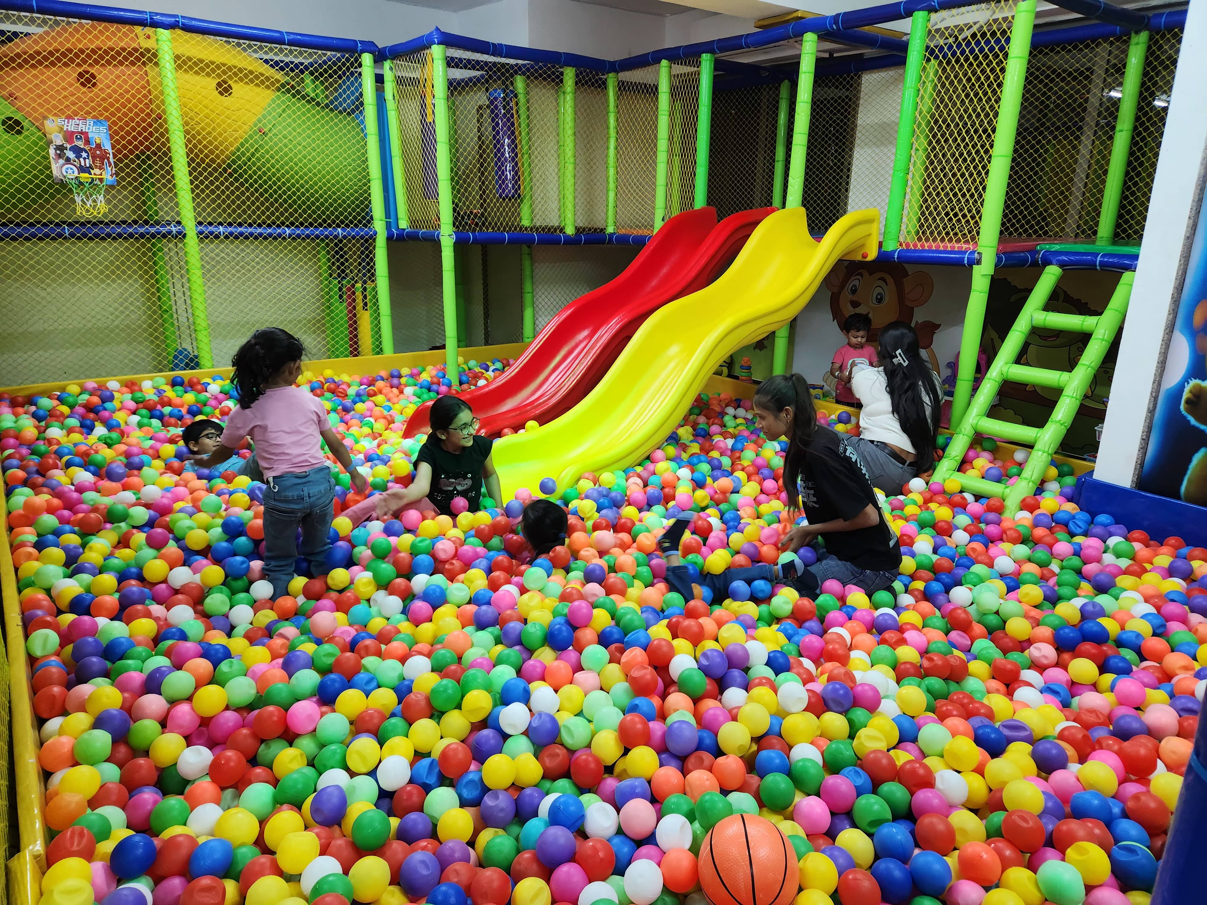 Colorful indoor play zone with slides and ball pit
